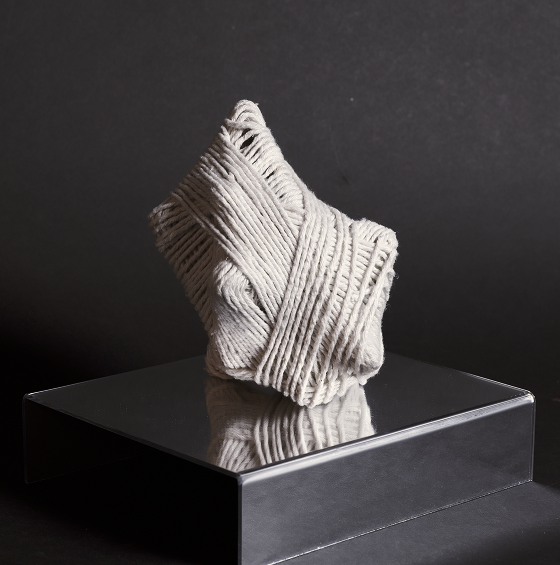 ScentLink — woven scent diffuser sculpture on a mirrored plinth